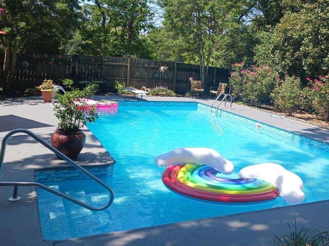 view of swimming pool with a patio area