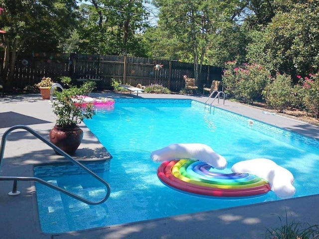 view of pool with a fenced in pool, a diving board, fence private yard, and a patio area