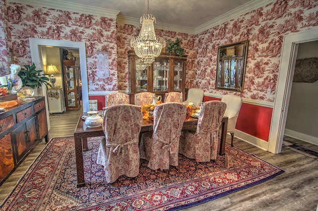 dining area with ornamental molding and hardwood / wood-style flooring