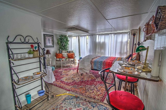 living room featuring tile walls and a textured ceiling