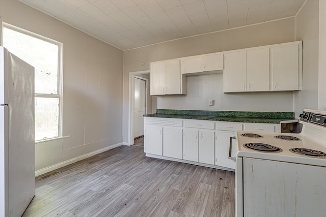 kitchen featuring light wood-type flooring, white appliances, and white cabinets