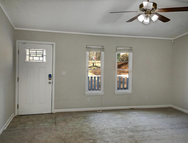 foyer entrance featuring a textured ceiling, crown molding, and ceiling fan