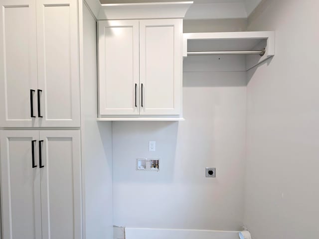 washroom with electric dryer hookup, hookup for a washing machine, and cabinets