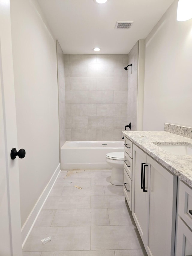 full bathroom featuring vanity, tiled shower / bath combo, and toilet