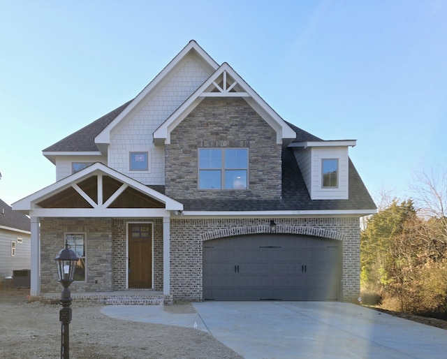 view of front of home featuring a garage and cooling unit