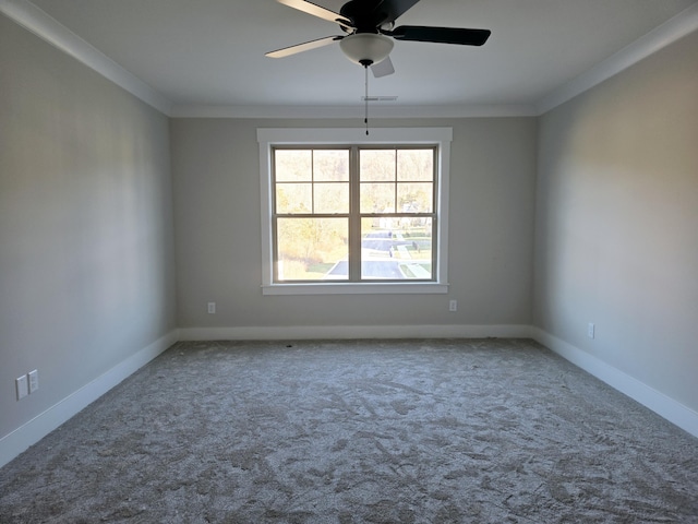 carpeted empty room with ceiling fan and crown molding