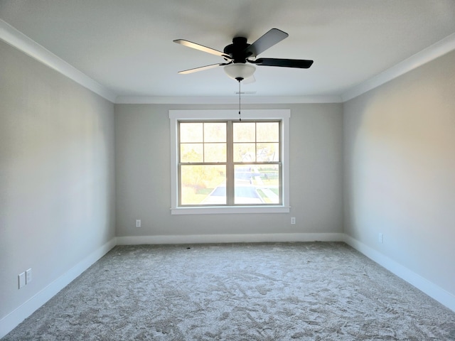 unfurnished room with carpet, ceiling fan, and crown molding