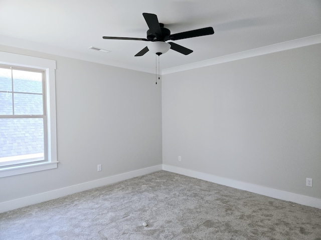 empty room with carpet, ceiling fan, and ornamental molding