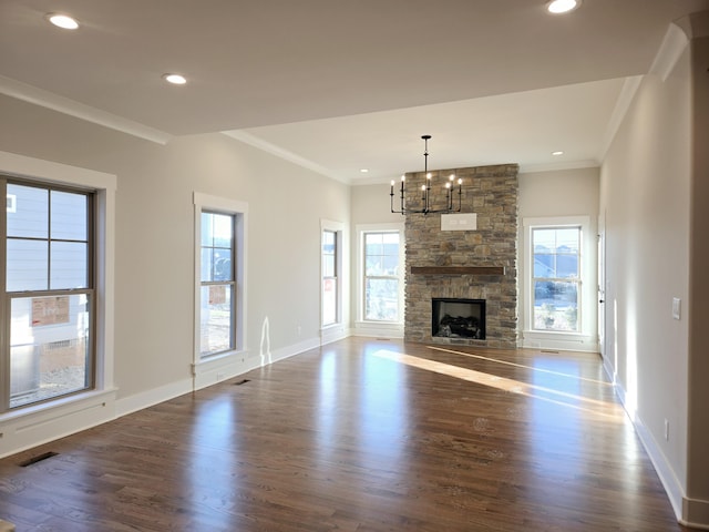 unfurnished living room featuring dark wood-type flooring, plenty of natural light, and ornamental molding