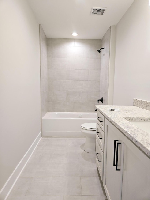 full bathroom featuring toilet, vanity, and tiled shower / bath