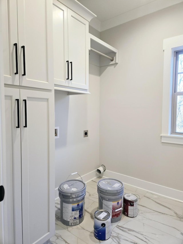 washroom with cabinets, crown molding, and electric dryer hookup