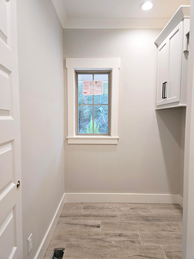 clothes washing area featuring light hardwood / wood-style floors