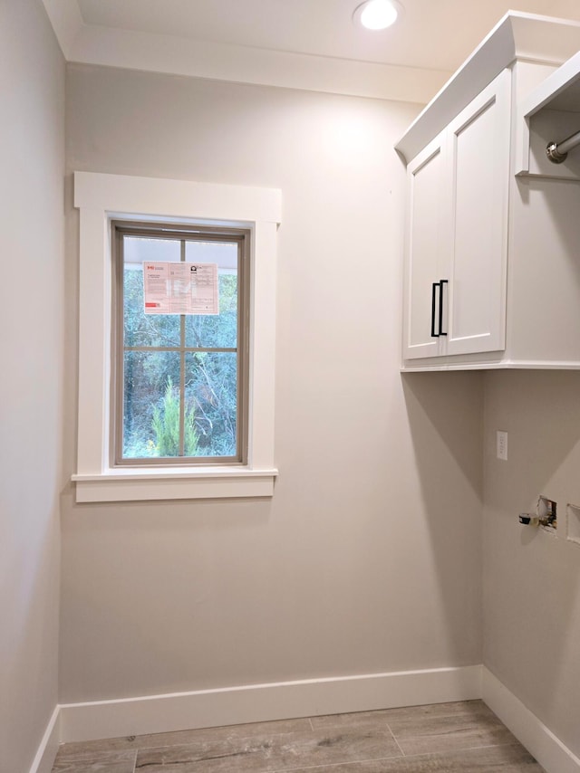 laundry area featuring light wood-type flooring