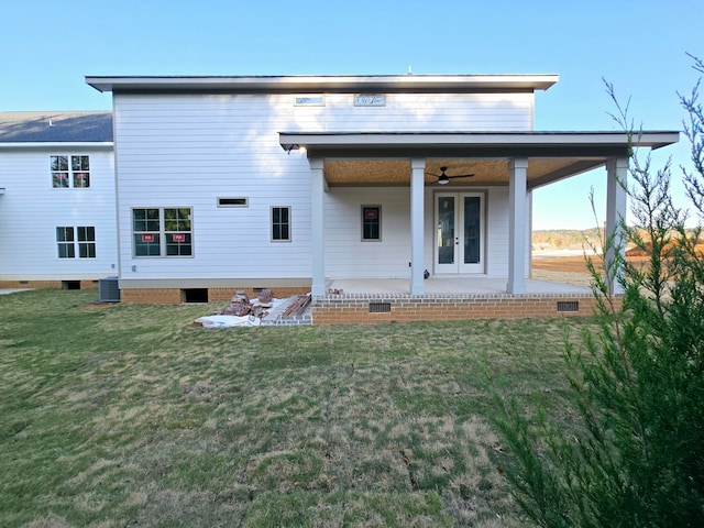 back of house with a lawn, ceiling fan, and central AC unit