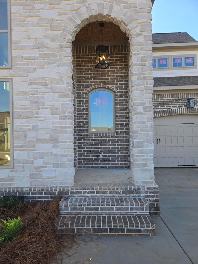 doorway to property featuring a garage