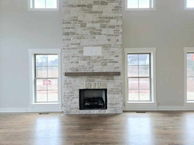 unfurnished living room with wood-type flooring and a wealth of natural light