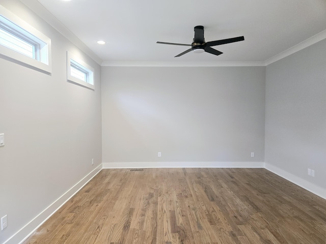 unfurnished room featuring ceiling fan, wood-type flooring, and ornamental molding