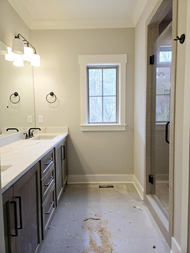 bathroom with crown molding, vanity, and an enclosed shower