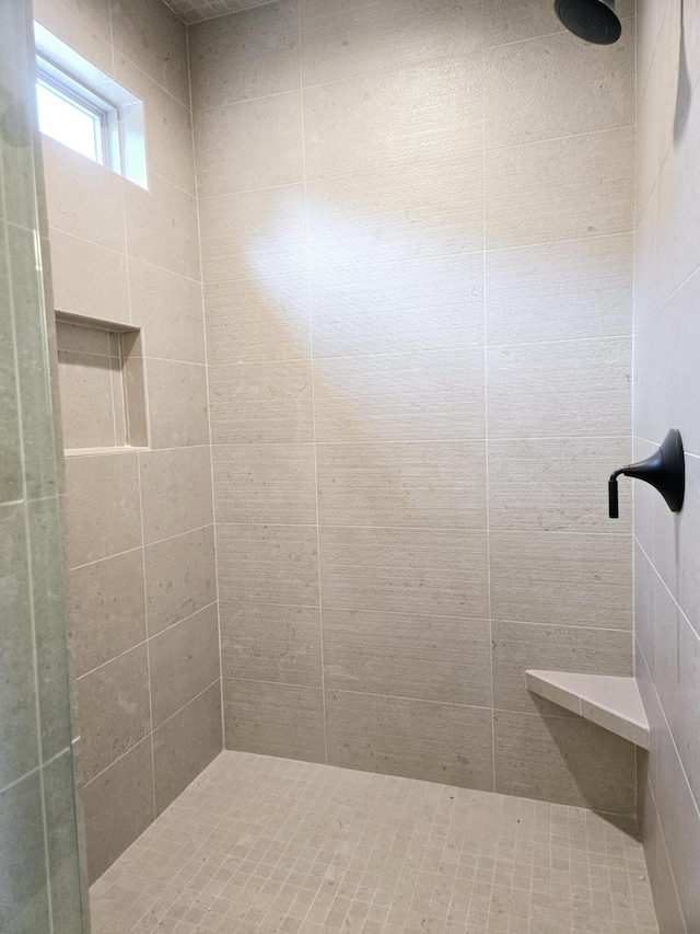 bathroom with a tile shower