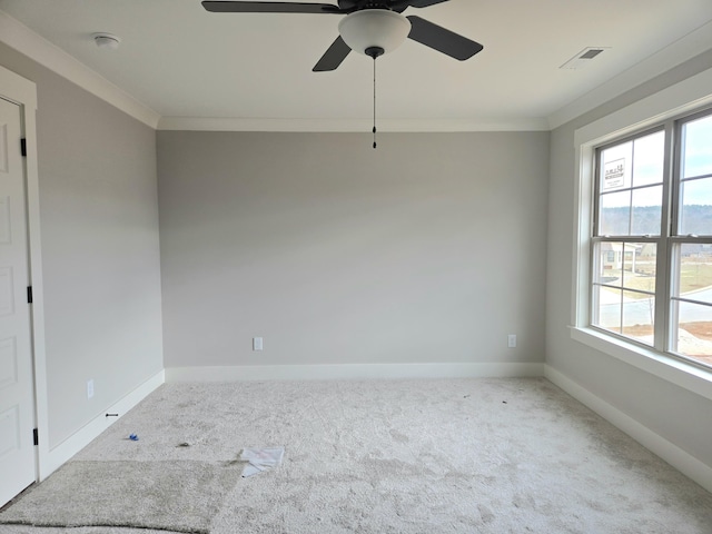 carpeted empty room with plenty of natural light, ornamental molding, and ceiling fan