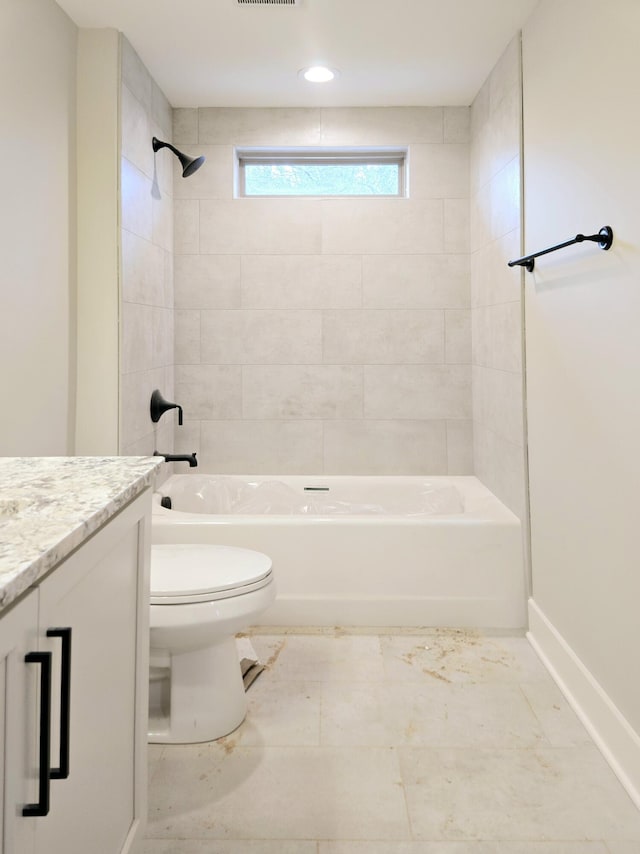 full bathroom featuring toilet, vanity, and tiled shower / bath combo