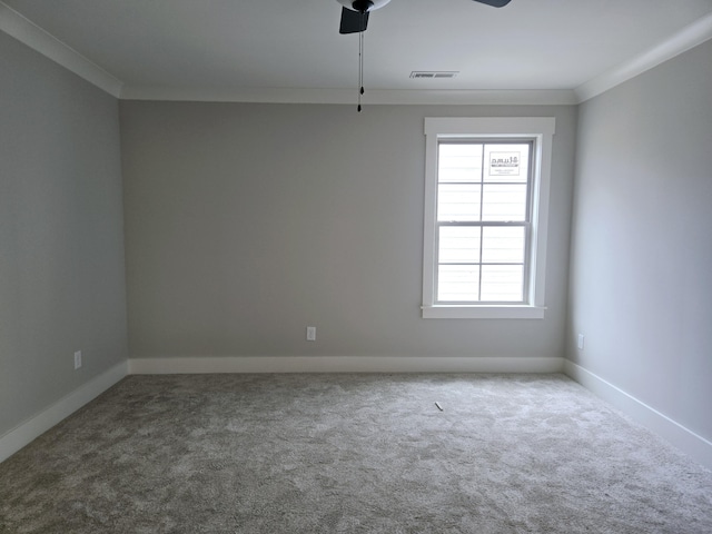 empty room featuring carpet flooring, ceiling fan, and crown molding