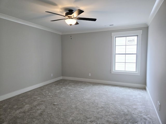 carpeted spare room featuring crown molding and ceiling fan