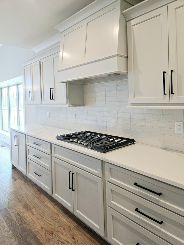 3297 Grassland Cir Unit 7, Apison, TN 37302 - kitchen featuring stainless steel gas stovetop, premium range hood, backsplash, and dark wood-style flooring