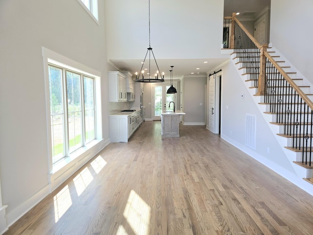 3297 Grassland Cir Unit 7, Apison, TN 37302 - interior space with a towering ceiling, visible vents, light wood-type flooring, light countertops, and a sink