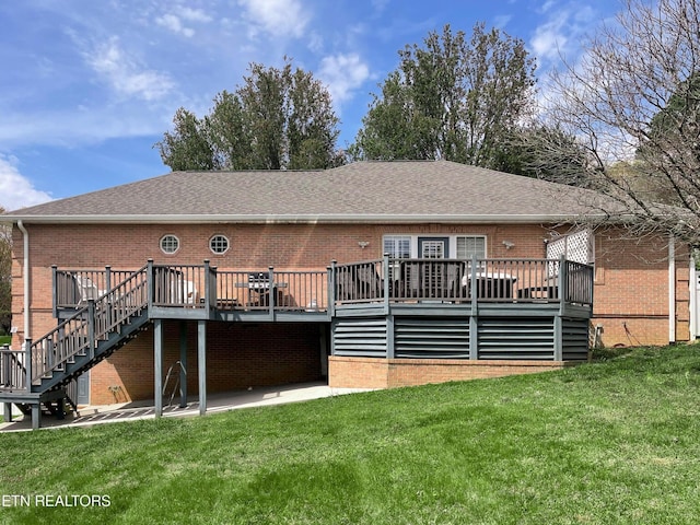 back of property featuring a lawn and a wooden deck