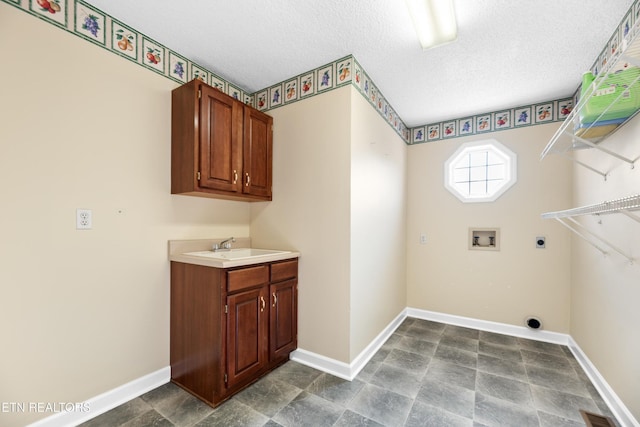 laundry area featuring sink, cabinets, washer hookup, hookup for an electric dryer, and a textured ceiling