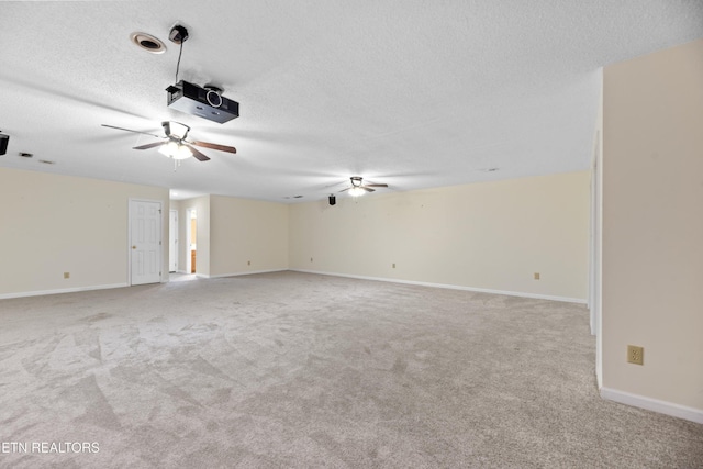 carpeted empty room with a textured ceiling