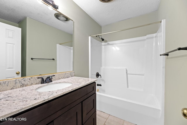 bathroom featuring tile patterned floors,  shower combination, vanity, and a textured ceiling