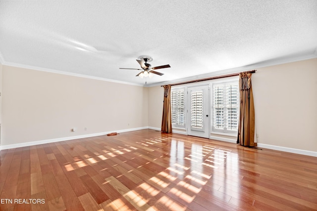 interior space with hardwood / wood-style floors, a textured ceiling, ceiling fan, and ornamental molding