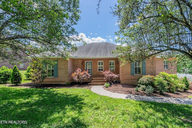 single story home featuring a front lawn