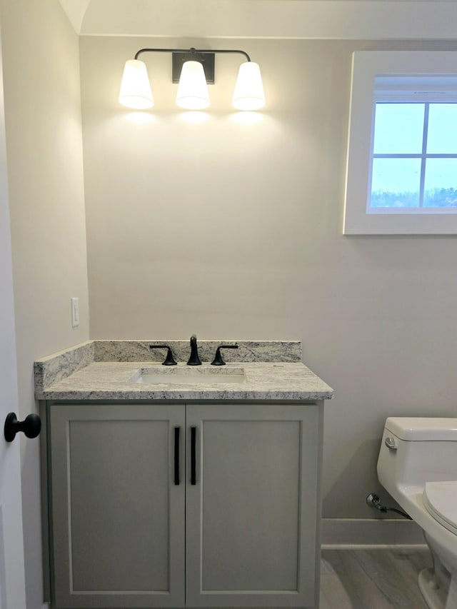 bathroom featuring toilet and vanity