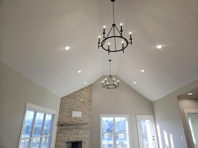 details featuring a brick fireplace and a notable chandelier