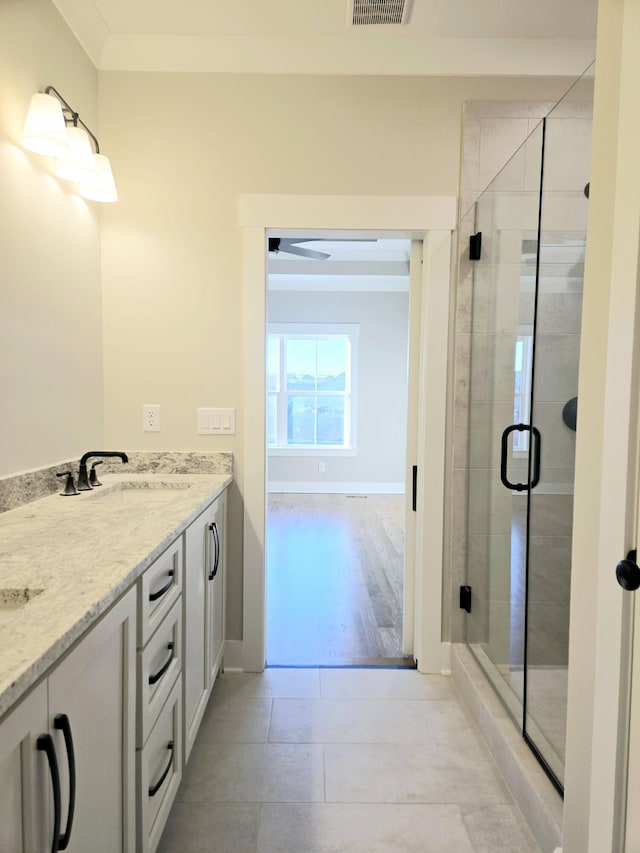 bathroom with tile patterned floors, an enclosed shower, and vanity