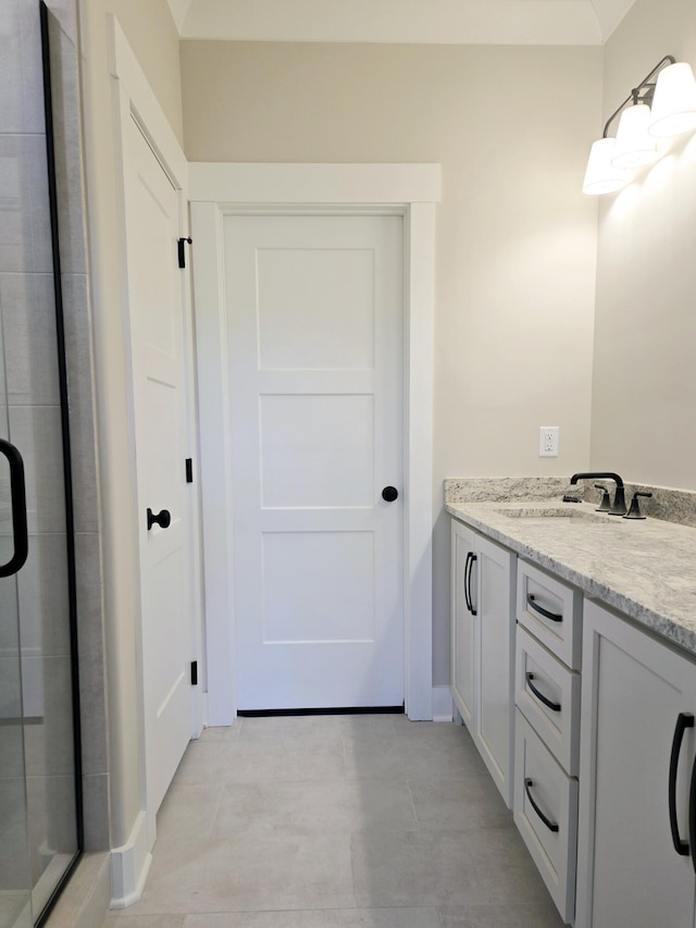 bathroom with walk in shower and vanity