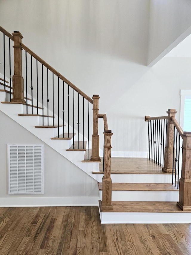 stairs featuring wood-type flooring