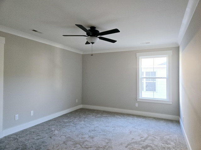 carpeted spare room with ceiling fan and ornamental molding