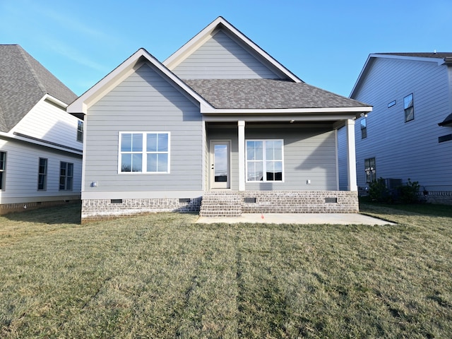 back of house with a lawn