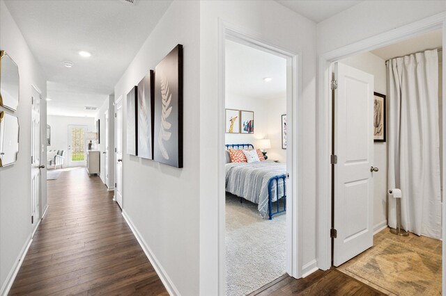 hall with dark wood-type flooring