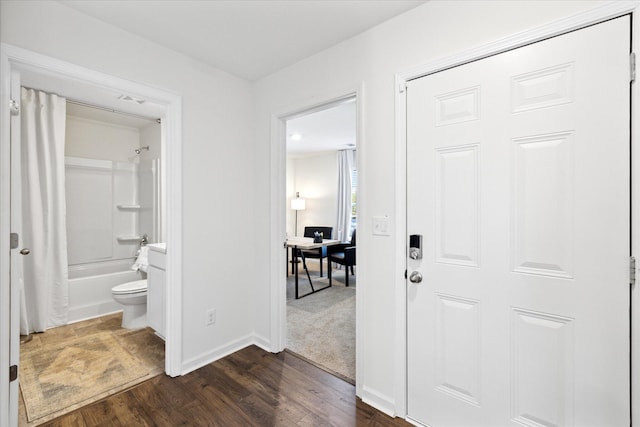 hallway with dark hardwood / wood-style flooring