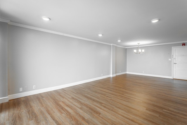 unfurnished room featuring crown molding, baseboards, a chandelier, recessed lighting, and wood finished floors