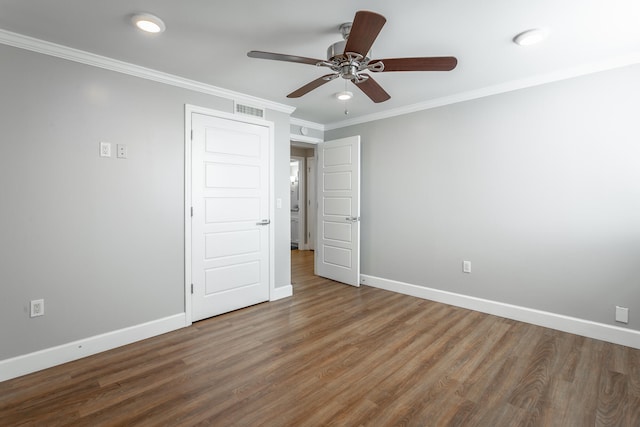 unfurnished bedroom with ceiling fan, ornamental molding, and hardwood / wood-style flooring