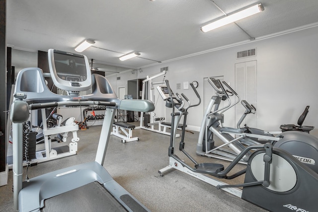 exercise room with visible vents and ornamental molding