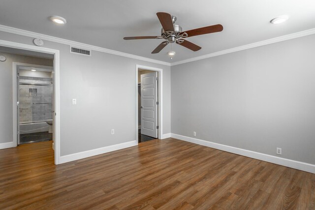 unfurnished bedroom with visible vents, baseboards, wood finished floors, and ornamental molding