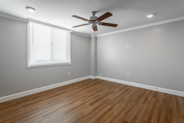 spare room featuring baseboards, crown molding, a ceiling fan, and wood finished floors