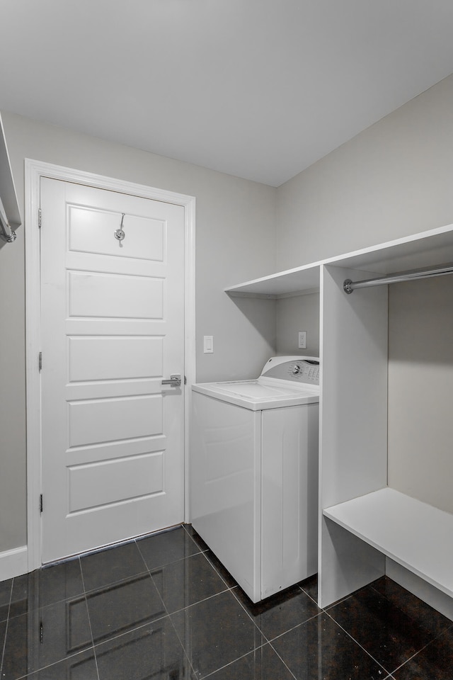 washroom with washer / clothes dryer and dark tile patterned flooring